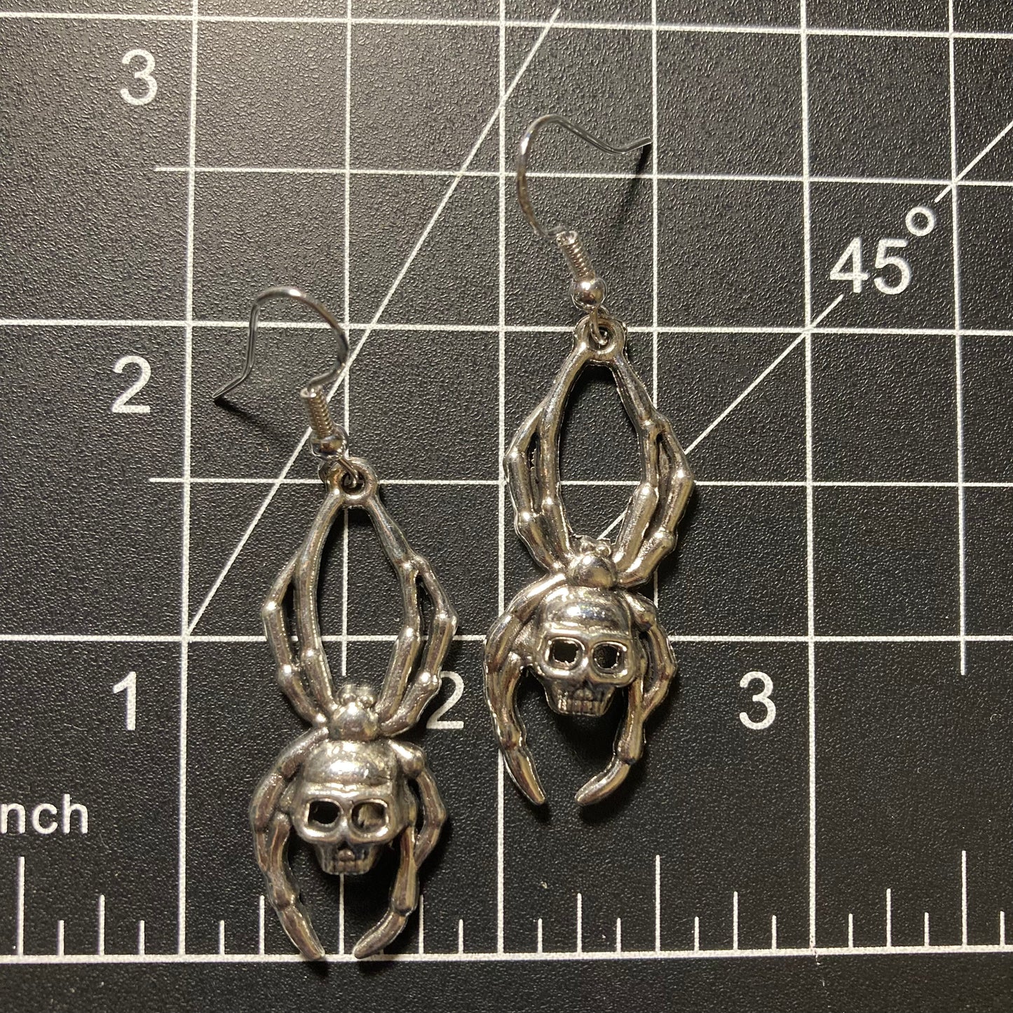 Spider with skull earrings